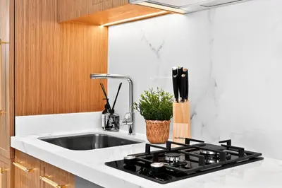 a kitchen with a sink and a counter top at Azizi Riviera Gateway - Highest Floor Superior Apartment in Dubai