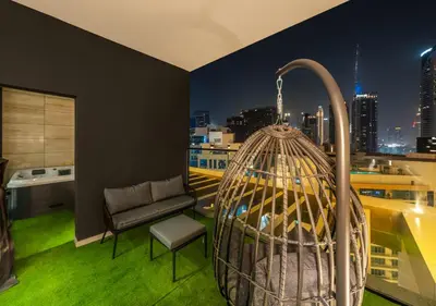 a room with a bird cage on a roof at Luxury 1 BR Apartment with Private Jacuzzi in Dubai