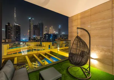 a room with a hammock and a view of a city at Luxury 1 BR Apartment with Private Jacuzzi in Dubai