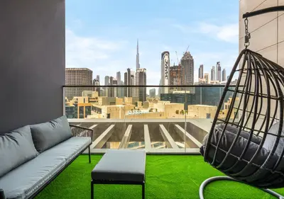 a living room with a swing and a view of the city at Luxury 1 BR Apartment with Private Jacuzzi in Dubai