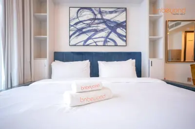 a bedroom with a bed with two towels on it at Bnbeyond Contemporary Living in Business Bay in Dubai