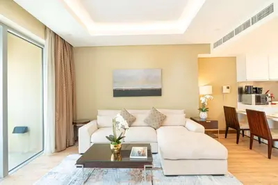 a living room with a white couch and a table at PVH - Emaar Fashion Avenue - 1BR Dubai Mall Access in Dubai