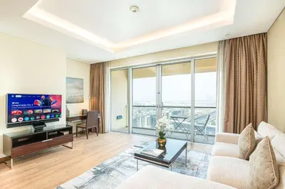 a living room with a couch and a flat screen tv at PVH - Emaar Fashion Avenue - 1BR Dubai Mall Access in Dubai