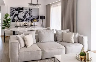 a living room with a couch and a table at Amazing, Spacious 2-bed with fantastic sea view! in Dubai