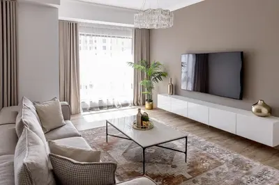 a living room with a couch and a tv at Amazing, Spacious 2-bed with fantastic sea view! in Dubai