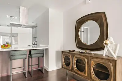 a bathroom with a mirror on the wall next to a counter at FIRST CLASS 2BR Spacious DIFC Living in Dubai