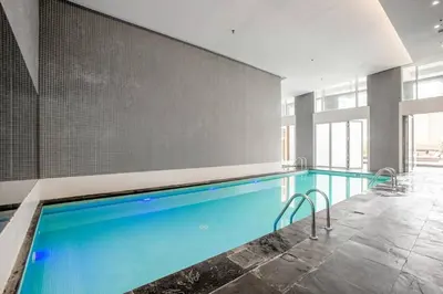 a large swimming pool in a building at FIRST CLASS 2BR Spacious DIFC Living in Dubai