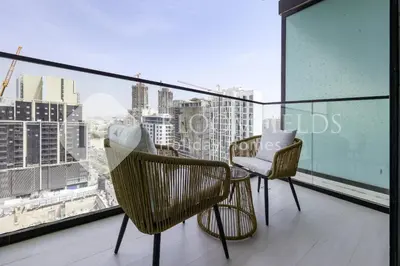 a balcony with two chairs and a view of a city at Bloomfields Fantastic Stu Binghatti Azure in Dubai