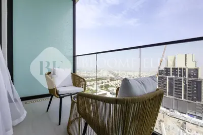 a room with two chairs and a large window at Bloomfields Fantastic Stu Binghatti Azure in Dubai