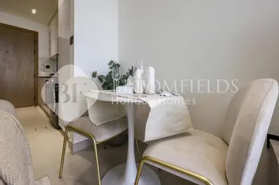 a dining room with a white table and chairs at Bloomfields Fantastic Stu Binghatti Azure in Dubai