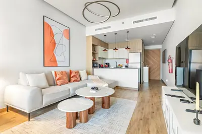 a living room with a couch and a table at FIRST CLASS Studio Minimalist Chic Retreat in Dubai