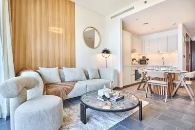 a living room with a couch and a table at STAY BY LATINEM Luxury 1BR Plus Study Holiday Home CB 3714 Near Burj Khalifa in Dubai