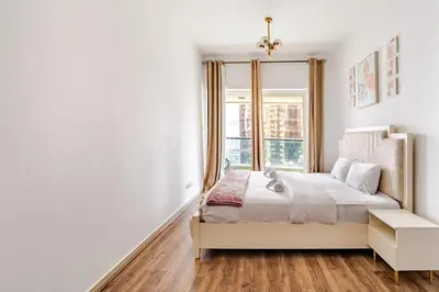 a bedroom with a bed and a window at Stunning lake view 1bedroom apartment in Jlt in Dubai