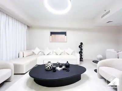 a living room with white furniture and a black coffee table at Skyline Elegance, Fountain View 3BR in Downtown in Dubai