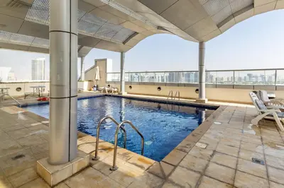 a swimming pool on the roof of a building at Waves - Cozy & Fully Furnished Studio in Dubai Sports City in Dubai