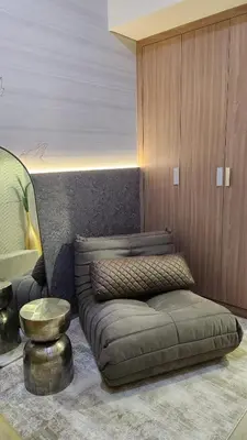 a living room with a brown couch and a stool at Charming Designed Apt - RIVIERA 26 Residence - Close to downtown in Dubai