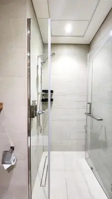 a shower with a glass door in a bathroom at Charming Designed Apt - RIVIERA 26 Residence - Close to downtown in Dubai