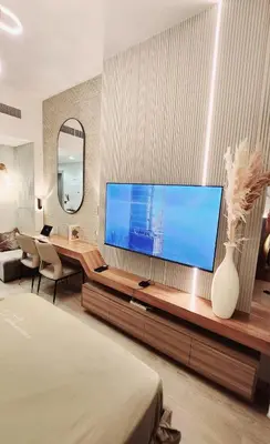 a living room with a large flat screen tv at Charming Designed Apt - RIVIERA 26 Residence - Close to downtown in Dubai