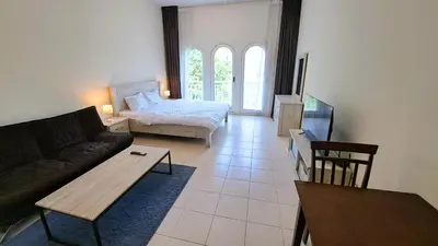 a living room with a couch and a bed at DRUVYA HOLIDAY HOMES, Building No 194, Street No,10 Discovery Gardens, Close to Al Furjan Metro 3 minutes walkable in Dubai