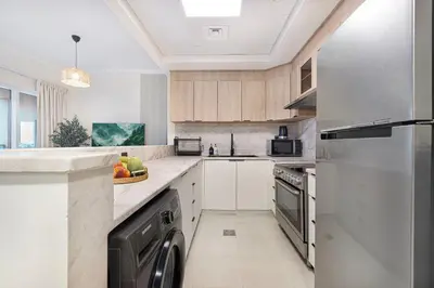 a kitchen with a sink and a dishwasher at The Haven Burj Khalifa View - 1BR Business Bay with Balcony&Pool in Dubai
