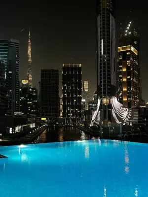 a view of a city skyline at night at The Haven Burj Khalifa View - 1BR Business Bay with Balcony&Pool in Dubai