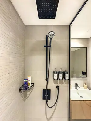 a shower in a bathroom with a sink at Deluxe Studio Business Bay - Balcony City Skyline Views in Dubai