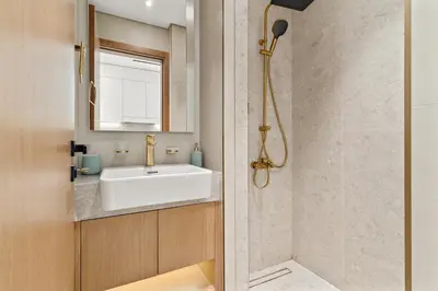 a bathroom with a sink and a shower at Modern Studio with Pool & Gym - Prime JVC Location in Dubai