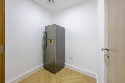 a refrigerator in the corner of a room at Exceptional 2BR with Marina Waterfront View in Dubai