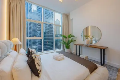 a large living room with a large window at Exceptional 2BR with Marina Waterfront View in Dubai