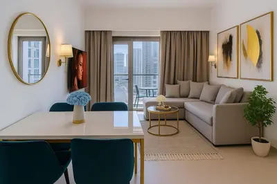 a living room with a couch and a table at Burj Royale 1BR - Close to Burj Khalifa and Dubai Mall in Dubai