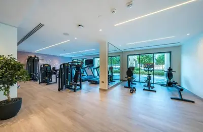 a gym with treadmills and ellipticals in a room at Burj Royale 1BR - Close to Burj Khalifa and Dubai Mall in Dubai