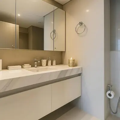 a white bathroom with a sink and a mirror at Burj Royale 1BR - Close to Burj Khalifa and Dubai Mall in Dubai