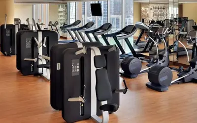 a gym with many rows of exercise equipment at The Glamorous in Dubai