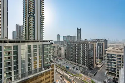 a view of a city with tall buildings at 1BR with Maid's Room, Few Minutes Drive to Downtown Dubai, Burj Khalifa, Dubai Mall, Close to Parks and Crystal Lagoons - The Crest Tower C, Sobha Hartland by Deluxe Holiday Homes in Dubai
