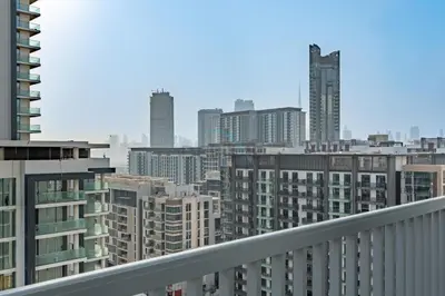 a view of a city skyline with tall buildings at 1BR with Maid's Room, Few Minutes Drive to Downtown Dubai, Burj Khalifa, Dubai Mall, Close to Parks and Crystal Lagoons - The Crest Tower C, Sobha Hartland by Deluxe Holiday Homes in Dubai