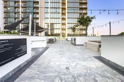 a tile walkway in the middle of a building at 1BR with Maid's Room, Few Minutes Drive to Downtown Dubai, Burj Khalifa, Dubai Mall, Close to Parks and Crystal Lagoons - The Crest Tower C, Sobha Hartland by Deluxe Holiday Homes in Dubai