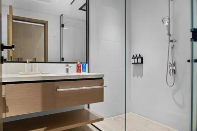 a bathroom with a sink and a shower at Palace Residence Chic 2BR Creek Beach View in Dubai
