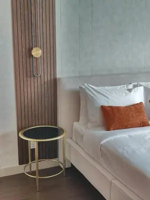 a bedroom with a bed with a table next to it at Newly Furnished Luxury 2BR - Perfect for a Family Getaway in Dubai