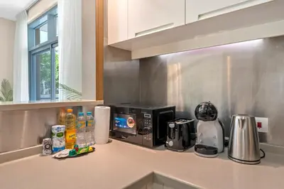 a kitchen counter with a microwave and a coffee maker at Lux Upscale Living Walk to Dubai Mall in Dubai