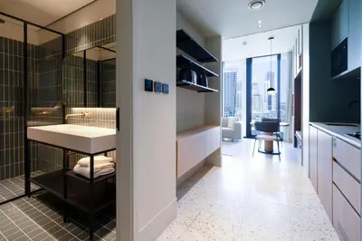 a bathroom with a shower and a sink in a room at Modern Studio, Burj Khalifa View, Upside Living in Dubai
