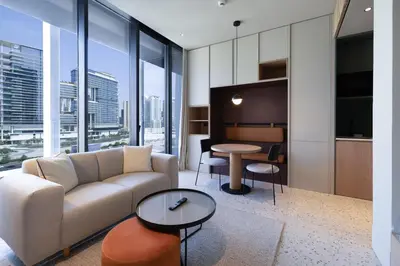 a living room with a couch and a table at Modern Studio, Burj Khalifa View, Upside Living in Dubai