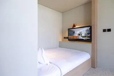 a bedroom with a bed and a flat screen tv at Modern Studio, Burj Khalifa View, Upside Living in Dubai