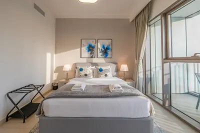 a bedroom with a large bed and a large window at Upscale 2BR with Burj Khalifa Views in Dubai