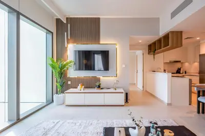 a kitchen and a living room with a sink in a room at Upscale 2BR with Burj Khalifa Views in Dubai