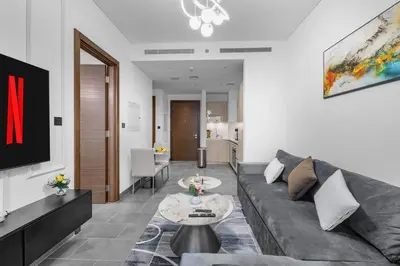 a living room with a couch and a table at Chic Urban Escape Sobha Crest 1BR with Private Balcony in Dubai