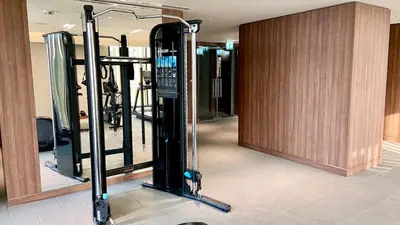 a gym with several tread machines in a room at Chic Urban Escape Sobha Crest 1BR with Private Balcony in Dubai