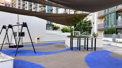 a playground in a building with a swing at Chic Urban Escape Sobha Crest 1BR with Private Balcony in Dubai