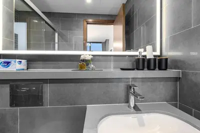a bathroom with a sink and a mirror at Chic Urban Escape Sobha Crest 1BR with Private Balcony in Dubai