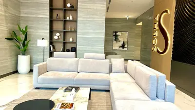 a living room with a white couch and a table at Chic Urban Escape Sobha Crest 1BR with Private Balcony in Dubai