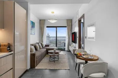 a living room with a couch and a table at Stylish 1BR Retreat in Sobha Crest with Balcony in Dubai